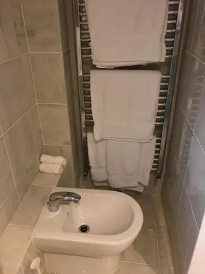 a bathroom with a white sink and towels at Orchard Manor in Probus