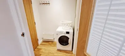 a washer and dryer in a small room at Romantic Hot Tub Breaks Marthys House Looe Polperro Talland Bay in Looe
