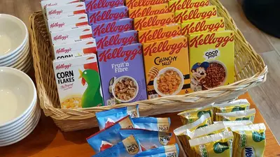 a basket of cereal and other snacks on a table at Geckos Rest in Newquay