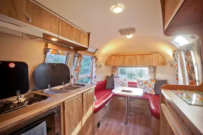 a kitchen and living room of an rv at Vintage glamping Airstream with Farm Animals in Penryn