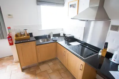 a kitchen with a sink and a counter top at Mannings Hotel in Truro