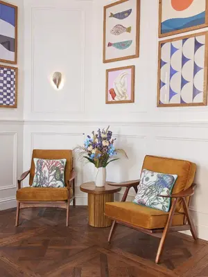 two chairs and a table with a vase of flowers at Harbour Hotel & Spa St Ives in St Ives