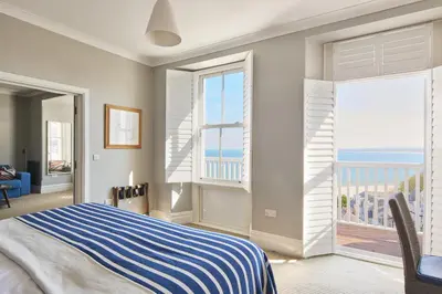 a bedroom with a bed and a view of the ocean at Harbour Hotel & Spa St Ives in St Ives