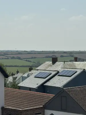 a row of houses with solar panels on their roofs at OYO Shore Surf Lodge in Newquay