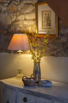 a table with a lamp and a basket on it at The Home Barn at Cornish Barn Holidays in Perranwell