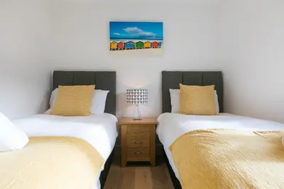two twin beds sitting next to each other in a room at Tara in St Ives