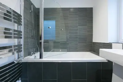 a bathroom with a tub and a sink at Tara in St Ives