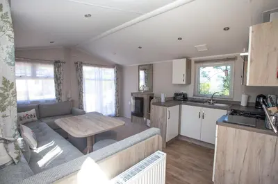 a living room and kitchen with a couch and a table at Little treamble holidays in Cubert