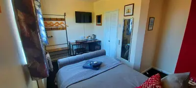 a bedroom with a bed with a blue hat on it at Sportsmans Valley Hotel in Liskeard