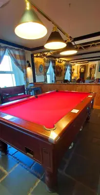 a pool table in a room with a red cloth at Sportsmans Valley Hotel in Liskeard