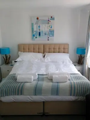a bed with two towels on top of it at Tregony Guest House in St Ives