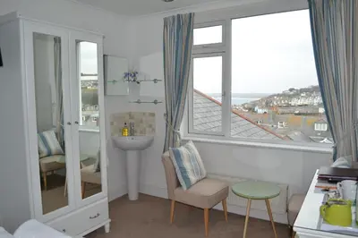 a bathroom with a sink and a window at Tregony Guest House in St Ives