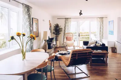 a living room with a table and chairs at Harvest Moon in Newquay