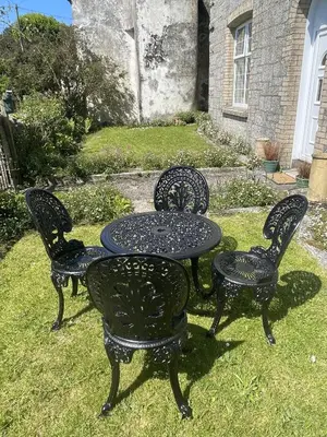 a table and four chairs and a table and a table and chairs at Treganoon House, Lanlivery in Bodmin