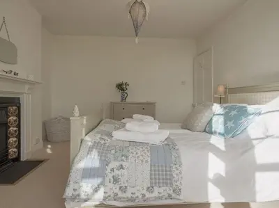 a bedroom with a bed with towels on it at 1 Florence Place in Falmouth