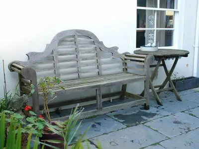 a wooden bench sitting next to a table at 1 Florence Place in Falmouth