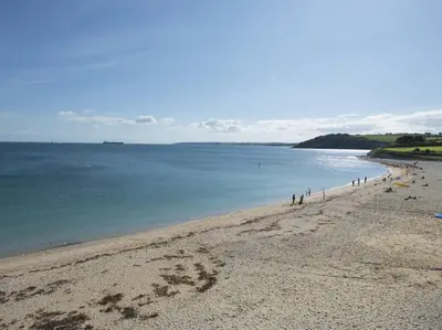 a group of people walking on a beach at 1 Florence Place in Falmouth