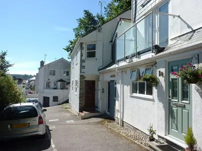 a car parked in front of two white houses at Stones Throw in Saint Mawes