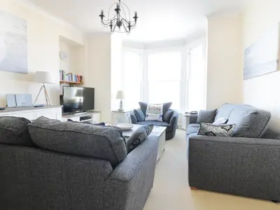 a living room with two couches and a tv at Seashore House in Newquay