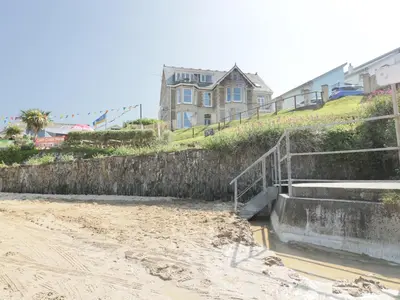 a house sitting on top of a hill next to a canal at Seashore House in Newquay