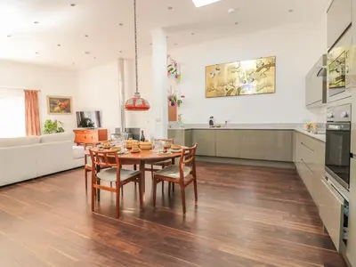 a kitchen and dining room with a table and chairs at Chy Lagen Hos in Newquay