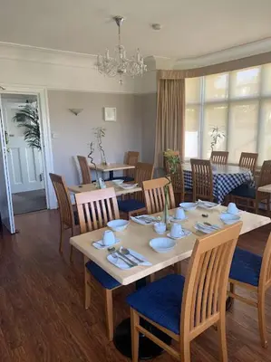 a dining room with a table and chairs at The Red House Guest House in Falmouth