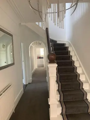 a hallway with a staircase in a house at The Red House Guest House in Falmouth