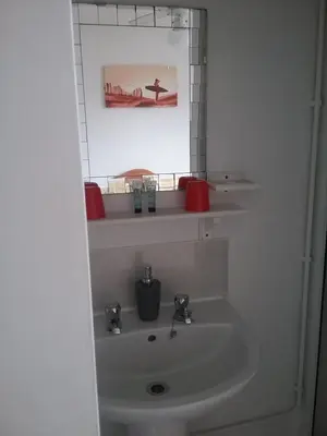 a bathroom with a sink and a mirror at Fairways Guest House in Newquay