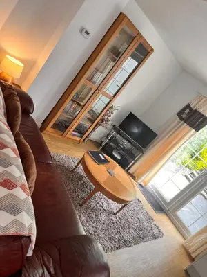 a living room with a couch and a television at The Cottage in Redruth