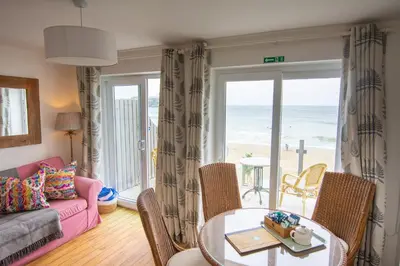 a living room with a view of the beach at Tolcarne Beach Apartments in Newquay