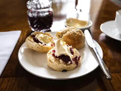 a white plate with four pastries on a table at Pengelly Farmhouse B&B in Truro