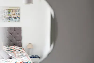 a bedroom with a bed and a mirror at Palace Guesthouse in Newquay