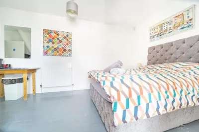 a bedroom with a bed and a desk in it at Palace Guesthouse in Newquay