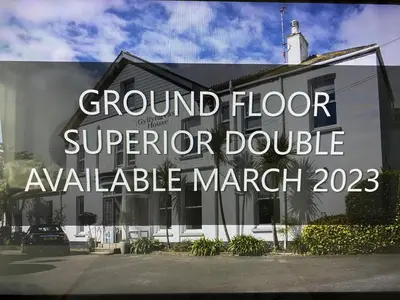 a building with a sign that reads ground floor superior double available at Gyllyngvase House in Falmouth