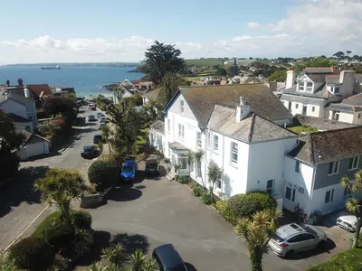 an aerial view of a town with houses and the ocean at Gyllyngvase House in Falmouth