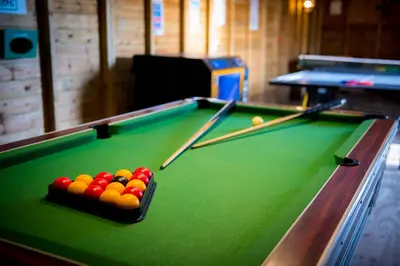 a pool table with billiard balls on top of it at St. Tinney Farm in Bude
