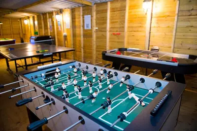 a foosball table with a group of people on it at St. Tinney Farm in Bude