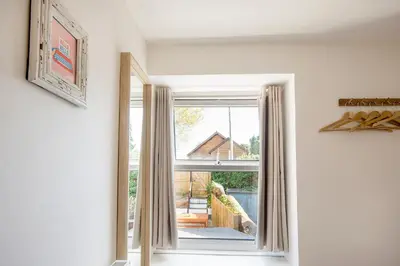 a window with a view of a house at Cornish Cottage - Truro City Centre in Truro