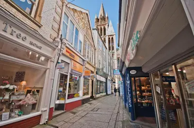 a city street with many shops and buildings at Cornish Cottage - Truro City Centre in Truro