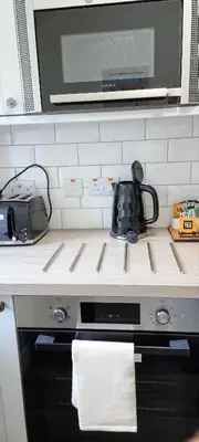 a kitchen counter with a microwave and a stove top oven at Tregenna Castle Resort in St Ives