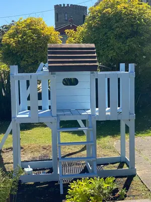 a blue bird house sitting in the grass at WE ARE UNIQUE ! 4 min walk to Beach, Pubs, Restaurants, Shops, Htd Pool, Hottub, Games rm, 1 acre Garden, BBQ's Coast to Coast cycle path, Beautiful, Bassets acre, Only six 1-3 bedroom SUPERB apartments, Free Parking and WIFI in Portreath