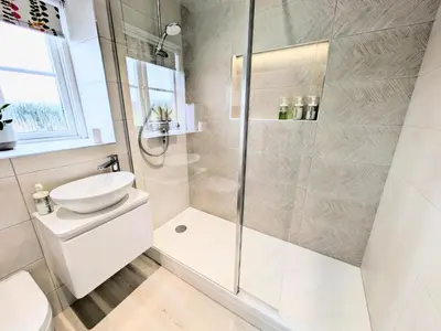 a bathroom with a shower and a toilet and a sink at Lanhydrock View in Bodmin