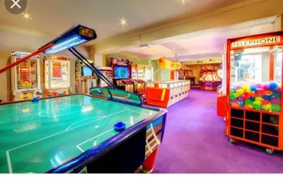 a childrens play room with a pool table and games at Take me to the beach at J&S caravan holidays Newquay Bay resort in Saint Columb Minor