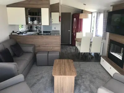a living room with a couch and a table at Par Sands Coastal Holiday park in Par