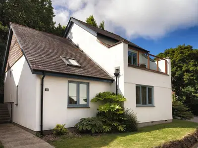 a white house with a black roof at Holiday Home Villa Gallery by Interhome in Perranwell