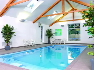 a swimming pool in a house with wooden beams at Holiday Home Villa Gallery by Interhome in Perranwell