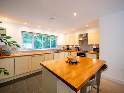 a large kitchen with a wooden table in it at Holiday Home Villa Gallery by Interhome in Perranwell