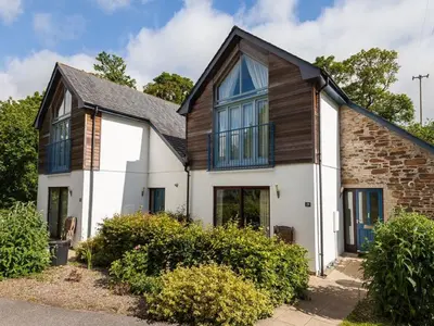 a white house with a black roof at Holiday Home Haven by Interhome in Perranwell