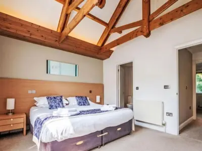 a bedroom with a large bed and wooden ceilings at Holiday Home Haven by Interhome in Perranwell