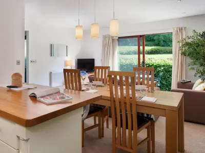 a kitchen and dining room with a table and chairs at Holiday Home Haven by Interhome in Perranwell